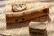 A wooden ethnic wind instrument on a bamboo mat.