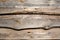 Wooden faded brown planking background with cracks and splits