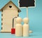Wooden family figurines, model house. Real estate purchase, rental concept
