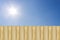 wooden fence with blue sky and sun shines