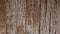 Wooden fence close-up. Old wooden fence made of raw wood. Textured wooden fence