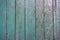 Wooden fence colored with turquoise paint