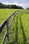 Wooden fence on grassland in summer farm