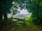 Wooden fence with a green grass meadow at the background. Camino de Santiago Primitivo