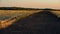 Wooden fence in the livestock feeding field, panoramic evening landscape