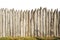 Wooden fence from logs isolated on white background. Fence from a stockade fence on white