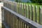 Wooden fence made of natural planks. the columns are made of roughly worked gray granite. fencing land in the mountains. meadow tr