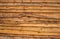 Wooden fence from oiled rough pine planks attached one on one. Horizontal wood texture