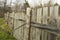 Wooden fence with a posts slightly askew on its side