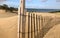 Wooden fence at the sand dunes with blue skies