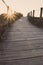 Wooden fence and walkway to beach faded. Empty path in sunlight. Walking concept. Camino de Santiago way.