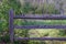 Wooden fenceing near river and forest land