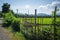 Wooden field fence beside road