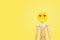 Wooden figure have feeling in love of face emotion with yellow background.