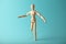 Wooden figure of man with artificial prosthetic leg. Amputee and disability concept