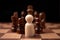 Wooden figures businessman standing confront of chess king and being in the chess circle. New business players are facing