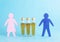 Wooden figures of a man and a woman on a blue background with bottles of alcohol. Family alcoholism concept, copy space for text