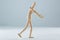 Wooden figurine pretending to push an invisible object