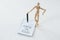 Wooden figurine standing besides a note pad which reads know the rules