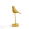 Wooden figurine of yellow bird with long legs. Minimalism. Scandinavian style