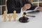 Wooden figurines of family with child and gavel on background of judge conducting divorce process.