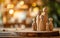 Wooden figurines representing a family are arranged on a rustic table, creating a heartwarming scene against a bokeh light