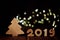 Wooden fir tree and text 2019 from wooden figure on dark wooden background with LED light garland. Horizontal view. New Year and