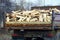 wooden firewood and logs in an iron truck