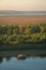 Wooden fishermen house inside water on Guadiana river between Spain and Portugal with beautiful tree landscape at sunrise