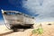 Wooden fishing boat left to rot and decay on the shingle beach at Dungeness, England, UK.