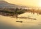 Wooden fishing boat sailing in mekong river on sunrise at border of thailand and laos