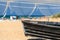 Wooden fishing boat on a sandy seashore with fishing nets hanging on blue sky background. Beautiful maritime landscape.