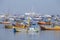 Wooden fishing boats and expensive yachts on the sea water near the city of Mumbai, India