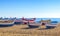 Wooden fishing boats rest on a golden sand beach