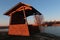 Wooden fishing cabin near large artificial fishing pond made from former gravel deposit.