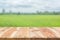 Wooden floor in front of blur color of the rice field