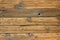 Wooden floor made of old boards with knots and cracks with rusty nails