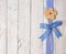 Wooden flower and blue ribbon