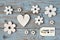 Wooden flowers, heart, black chalk board and thank you label on a blue grey knotted old wooden background with empty space layout