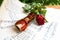 Wooden flute and a red rose on music scores