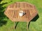 Wooden foldable acacia garden picnic table with a mug of tea