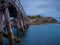 A wooden foot crossing bridge in La Perouse Sydney Botany Bay Australia on a cloudy dark rainy afternoon