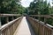 Wooden footbridge crossing high up over a forest