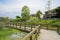 Wooden footbridge over the lake near countryside dwelling buildings