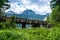 Wooden footbridge over stream against background of Meded Peak and Glacial Black Lake. Durmitor National Park. Montenegro