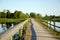 Wooden footbridge railings lake blur people walk