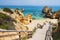 Wooden footbridge to beautiful beach Praia do Camilo near Lagos in Algarve region, Portugal