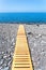 Wooden footpath on beach leading to portuguese sea