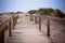 Wooden footpath through dunes at the ocean beach