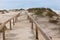 Wooden footpath through dunes at the ocean beach